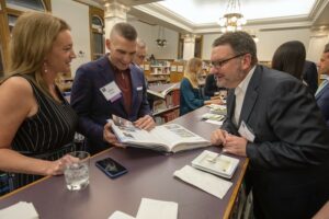 Milwaukee-Public-Library-Foundation-Ben-Franklin-Awards-Group-Looking-at-Book