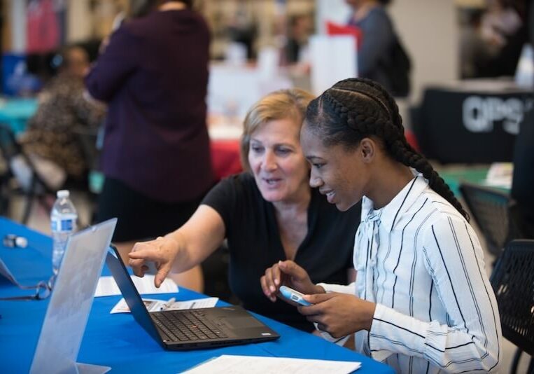 Milwaukee-Public-Library-Foundation-Woman-getting-help-with-job-application-at-job-fair